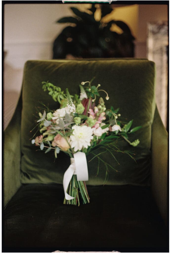 35mm film wedding photography of bridal bouquet on a green armchair