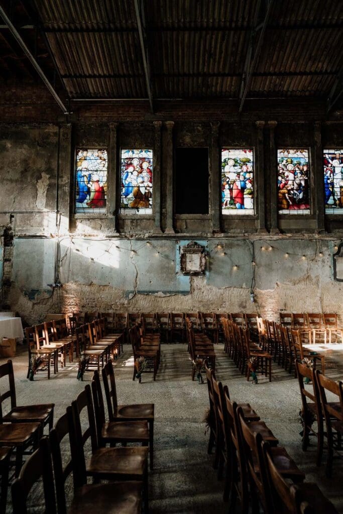 asylum chapel with light seeping through stained glass windows interiors