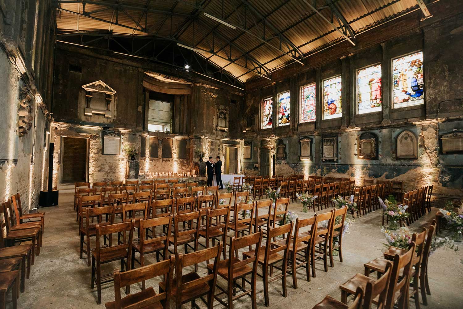 groom getting ready at the back of asylum chapel ceremony room
