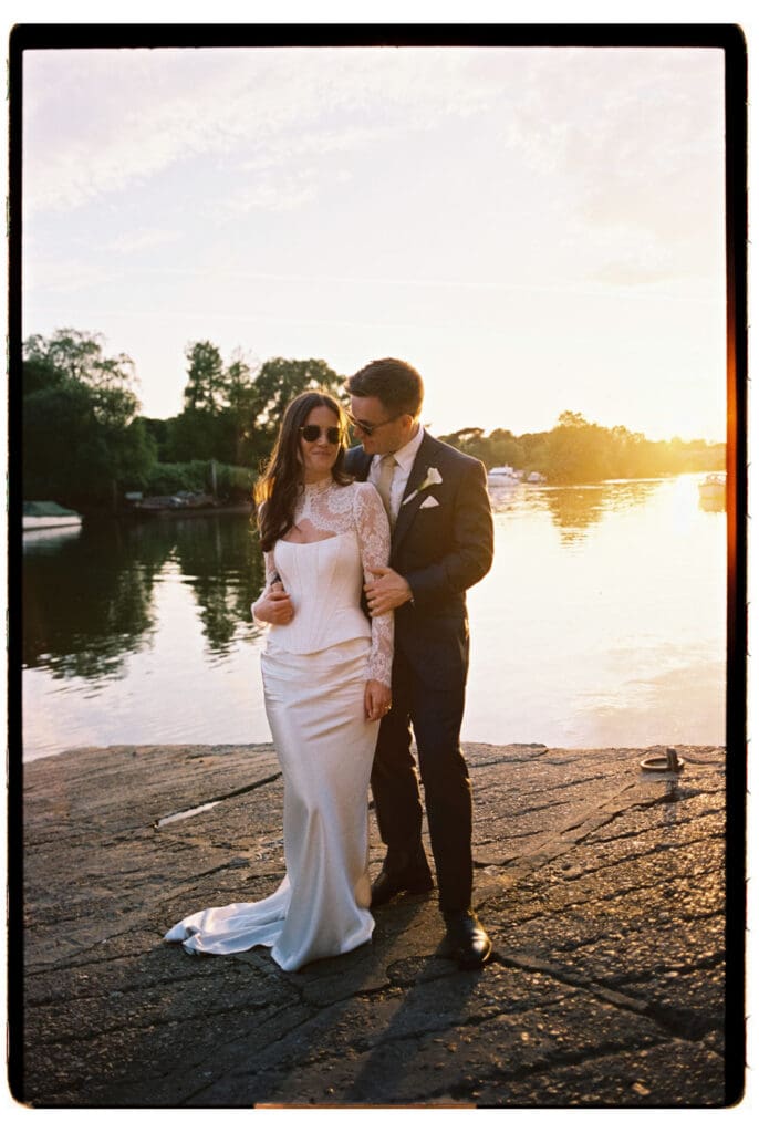Analogue wedding photography in Richmond Scotts riverside with a sunset behind the couple